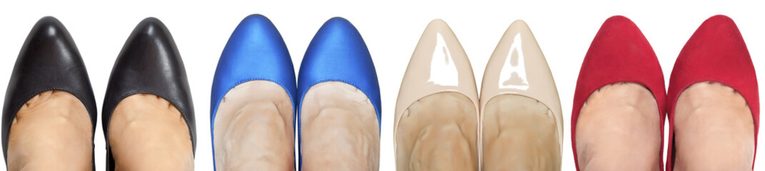 Four pairs of feet in shoes of different colors. Isolated on white background.