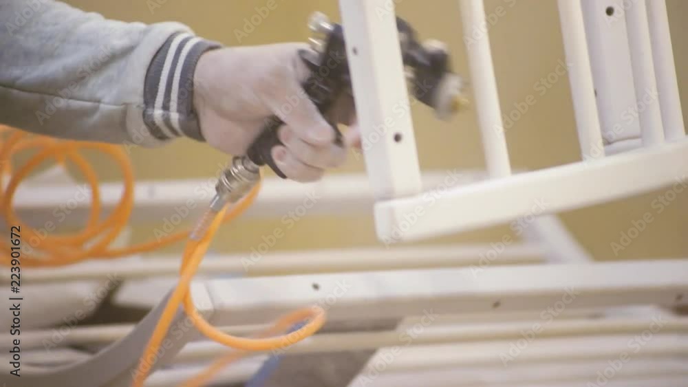 Poster close-up of a carpenter working on a wooden window frame with a file in his workshop. stock. profess