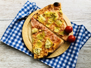Pizza slices with ham cheese and artichokes