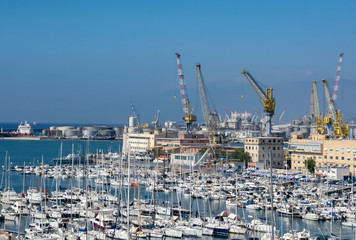 Fototapeta na wymiar tourist and commercial boats moored in neat rows in the port of Genoa, Liguria. Italy