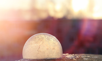 Soap bubbles freeze in the cold. Winter soapy water freezes in t