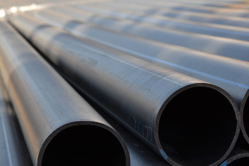 Fototapeta premium Plastic pipes in stock of finished products stacked in packs