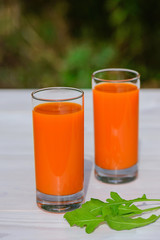 Carrot juice on a wooden table