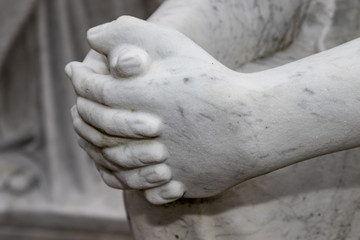 Marble hands clasped in prayer, Halifax, summer sun, no people, cemetery