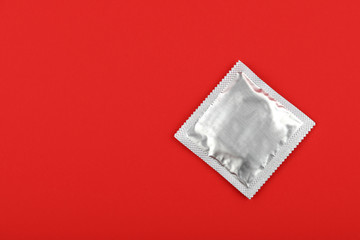 Close up one condom pack over red background