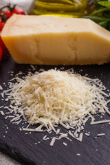 fragrant grated Parmesan on a slate stone slicing board