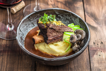 Slowly stewed beef short ribs with potato, mushroom and gravy.