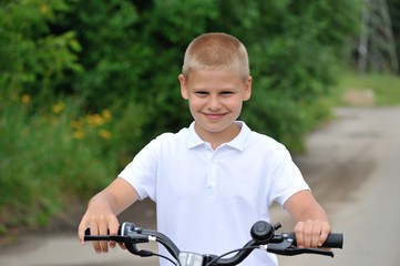 The boy is riding a bicycle