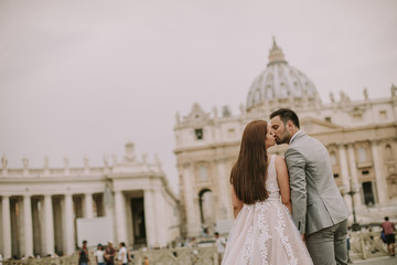 Young wedding couple by Saint Peter cathedral in Vatican