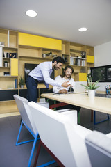 Obraz premium Two young businessmen working at office