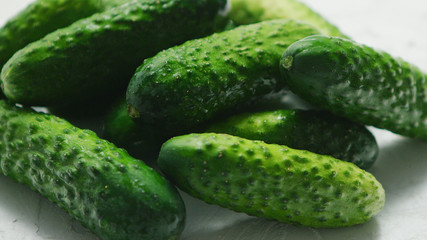 Closeup of textured pimply green cucumbers lying in small heap in soft daylight
