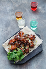 Baked chicken wings with sesame and sauce. Food background with copy space. Top view.