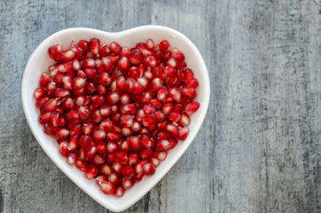 Pomegranate seeds  in white plate.
