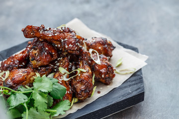 Close view of chicken wings with spicy sauce, copy space