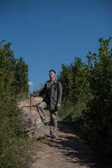 portarit of hiker standing on dirt path 