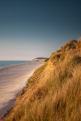Coastline panorama view with endless beaches and giant grass sand dunes at the northern danish sea. Løkken in North Jutland in Denmark, Skagerrak, North Sea