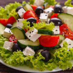 Greek salad on a wooden rustic background