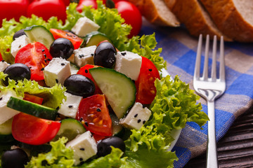 Greek salad on a wooden rustic background