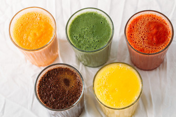 Colorful smoothies in glass with fresh tropical fruit and superfoods