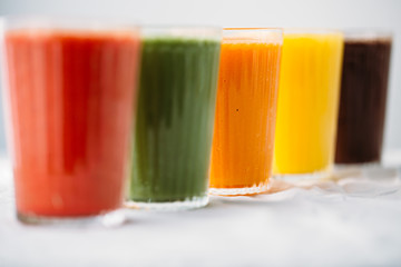 Colorful smoothies in glass with fresh tropical fruit and superfoods