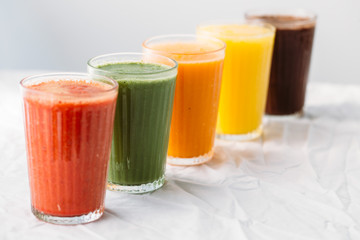 Colorful smoothies in glass with fresh tropical fruit and superfoods