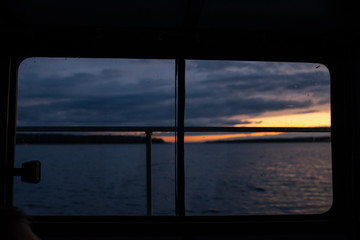 Sunset through window in motorboat