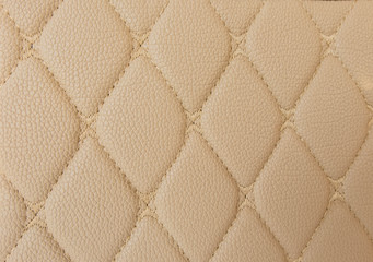 beige leather Mat with straight beige stitching soft leather for machine with textured pattern concept background business
