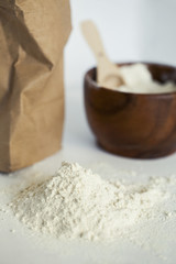 Kitchen still life with scattered flour on the white table. Closeup