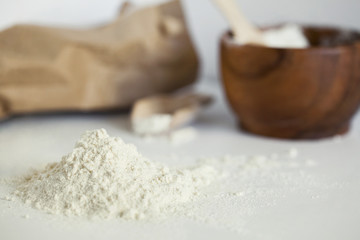 Kitchen still life with scattered flour on the white table. Closeup