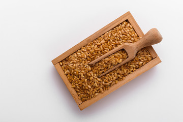 Seeds of golden flax on a white background