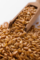 Seeds of golden flax on a white background