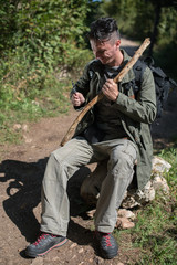 Fototapeta premium hiker preparing stick from old branch