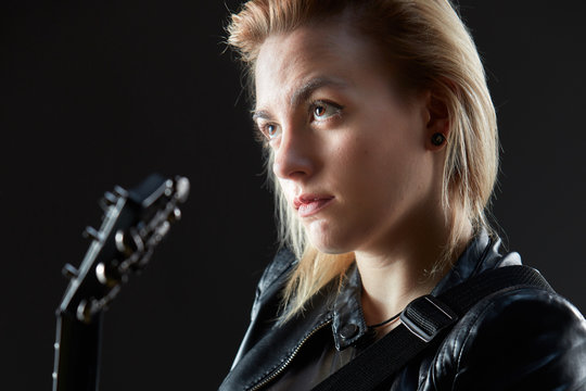Blonde woman rocker guitarist black dark scene