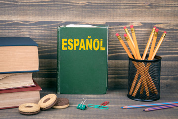 learn spanish concept. Book on a wooden background