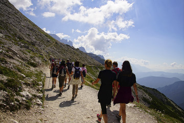Large group of hikers descend from an alpine hut