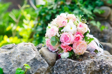 Wedding bouquet of the bride on the stone
