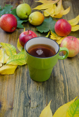 autumn leaves and red apples and a Cup of coffee 