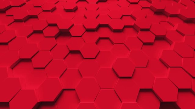 Abstract looping motion background texture of red hexagons.