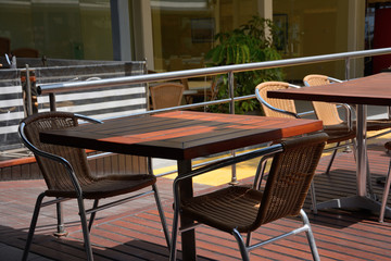 Wooden table and chairs in summer cafe. Free