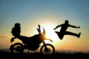 Obraz na płótnie Canvas silhouette of dynamic, energetic and positive motorcyclist