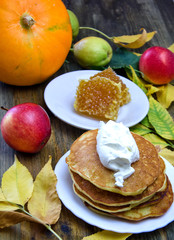  pumpkin pancakes next to honey