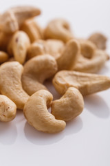 cashew nuts on a white acrylic background