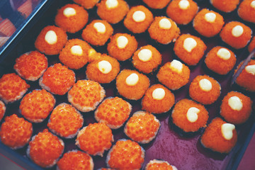 Fototapeta premium Japanese sushi arranged in a serving tray of a Japanese restaurant.