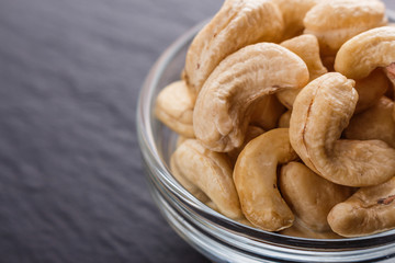 cashew nuts on a dark stone background