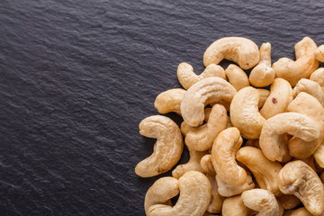 cashew nuts on a dark stone background