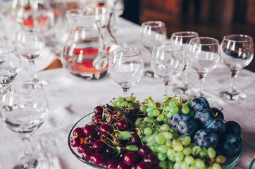 Glasses and fruits on the served table