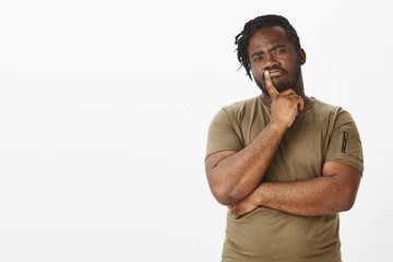 Guy making importrant decision. Portrait of smart thoughtful african boyfriend in military t-shirt,...