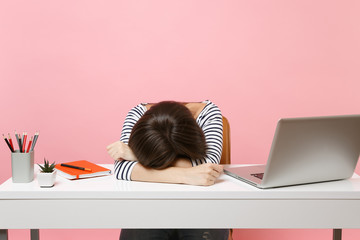 Young Disappointed Tired woman laid her head down on the table sit, work at white desk with...