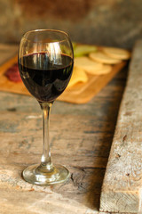 glass of red wine and a bottle on the table (alcohol). Top view. food background copy space