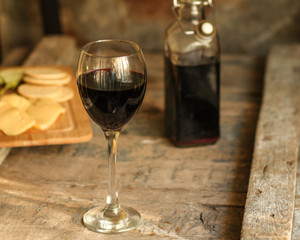 glass of red wine and a bottle on the table (alcohol). Top view. food background copy space